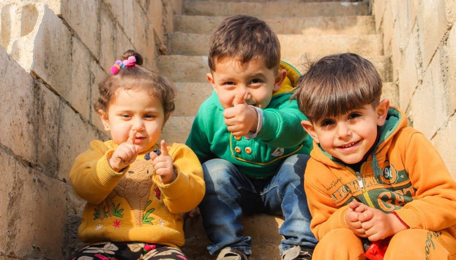 Three smiled children outdoor
