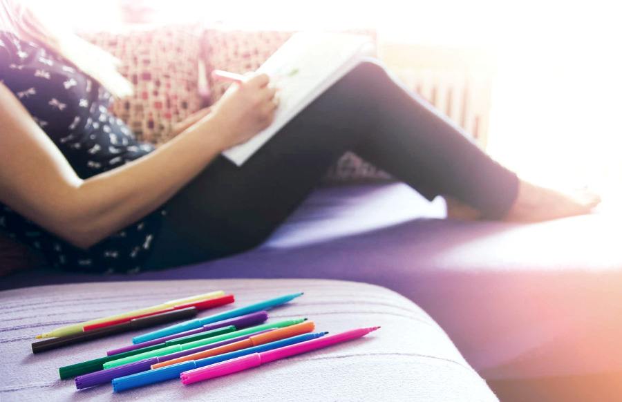Relaxed lady with pencils and coloring page