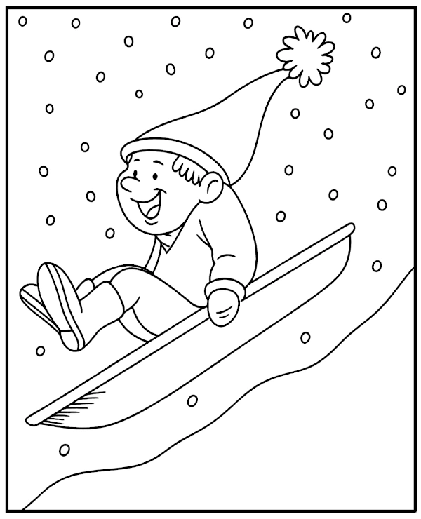 A boy sliding down a hill in winter